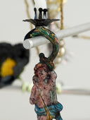 Decorative hook with a figurine of a woman holding a spear on a blurred background