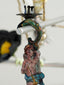 Decorative hook with a figurine of a woman holding a spear on a blurred background