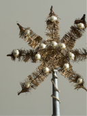 Decorative Christmas tree with gold tinsel and white ornaments on a gray background