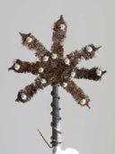 A brown fuzzy star tree topper with eight spiky arms, decorated with small clear rhinestones and mounted on a dark gray wrapped pole, shown against a plain light gray background.